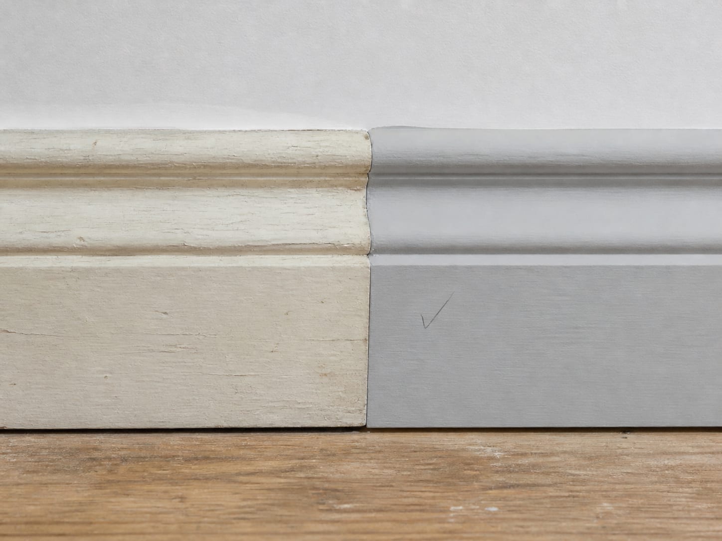 A butt joint where newly milled primed trim meets original aged trim, the two profiles close but not identical and the difference visible at the joint, in Alpine, New Jersey