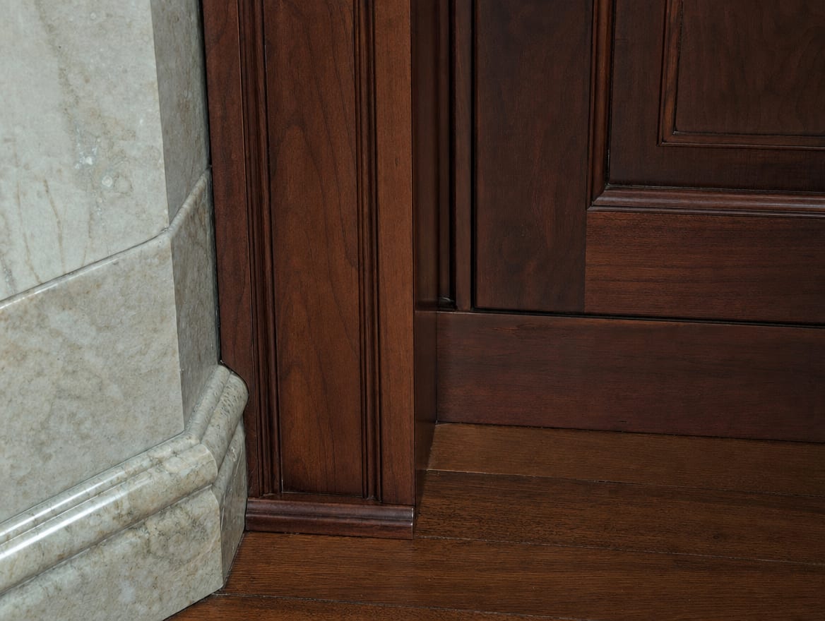 A new run of custom millwork being fitted against original stone and cabinetry in a Deal home so the rebuilt finish matches what was there before