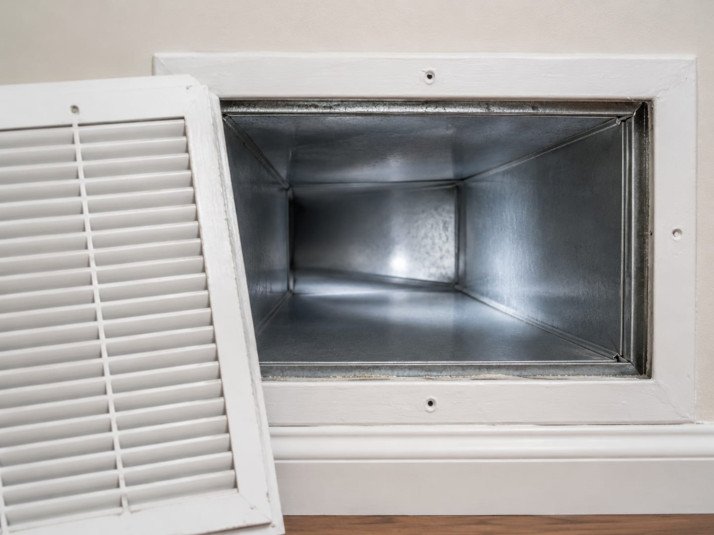 A clean supply register removed to reveal a bright, dust-free duct interior in a New Jersey home, conveying a thorough air duct cleaning result
