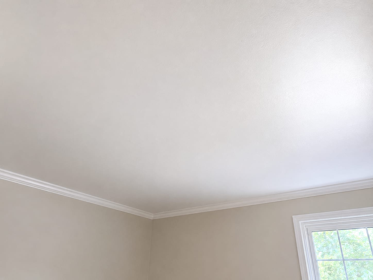 Fully restored and freshly painted clean white ceiling in an empty New Jersey residential room after completed mold remediation