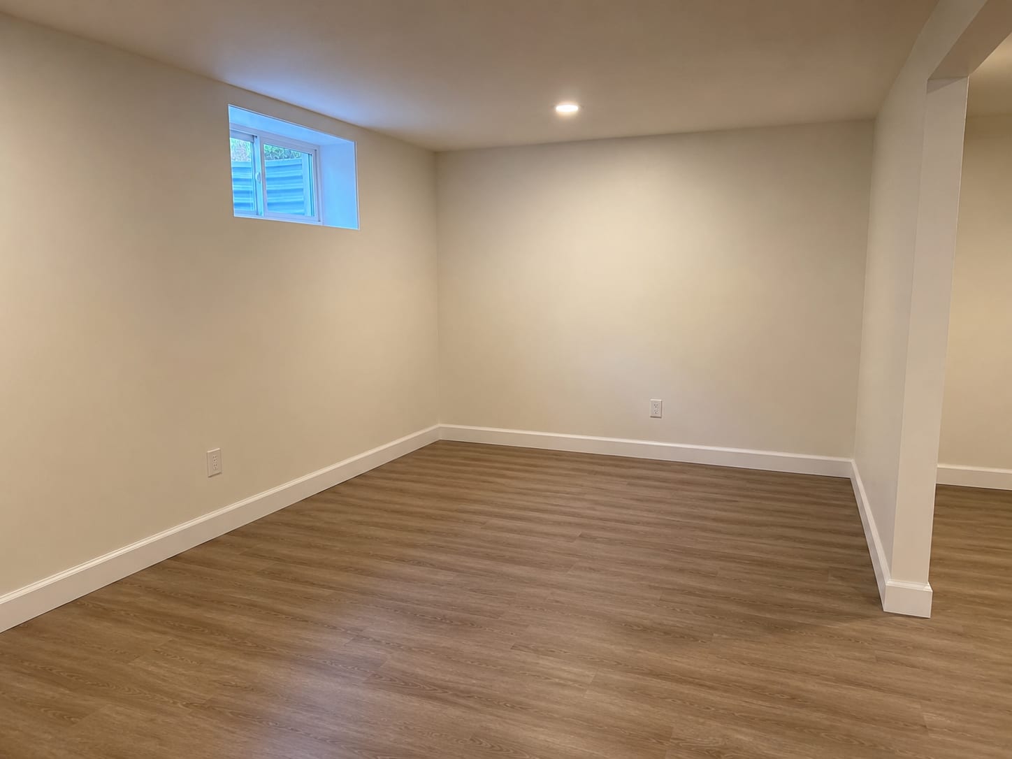 Clean finished basement interior after complete mold remediation and build-back, showing new drywall, painted walls, and restored living space in a New Jersey home
