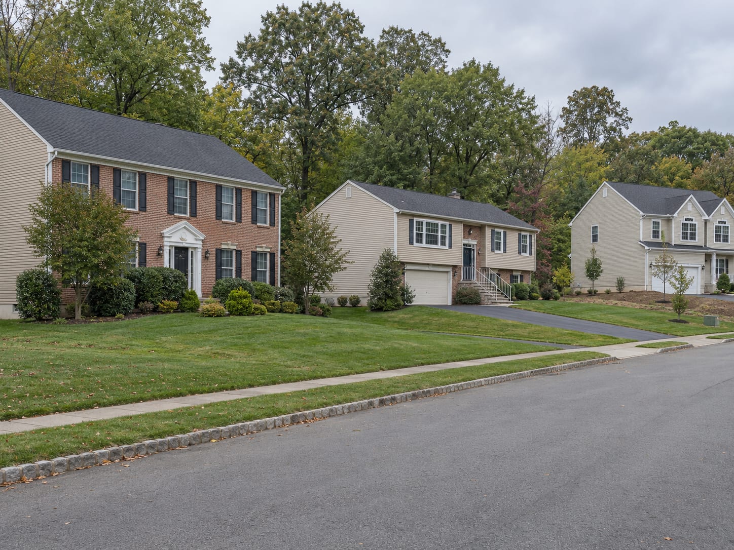 Raised ranches and two storey colonials with brick and vinyl fronts, attached garages and wooded lots, in Ten Mile Run, New Jersey