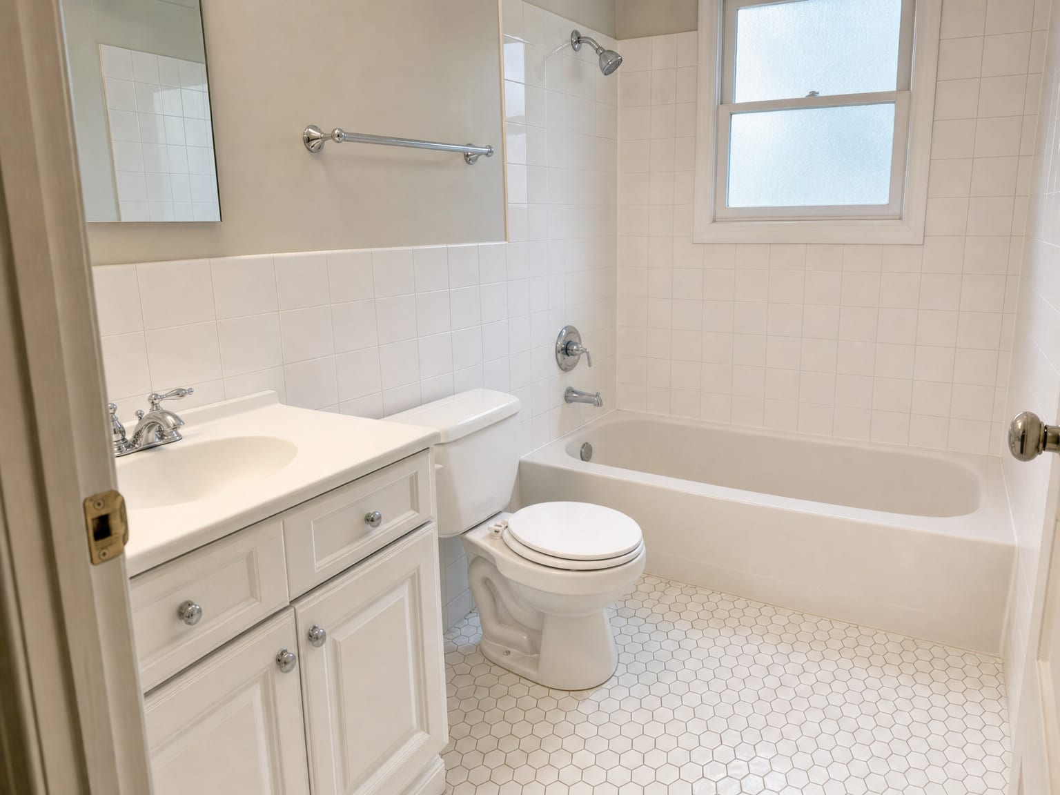 Vacant kitchen with cleaned stainless steel appliances, wiped cabinet fronts, and spotless countertops in an empty New Jersey home