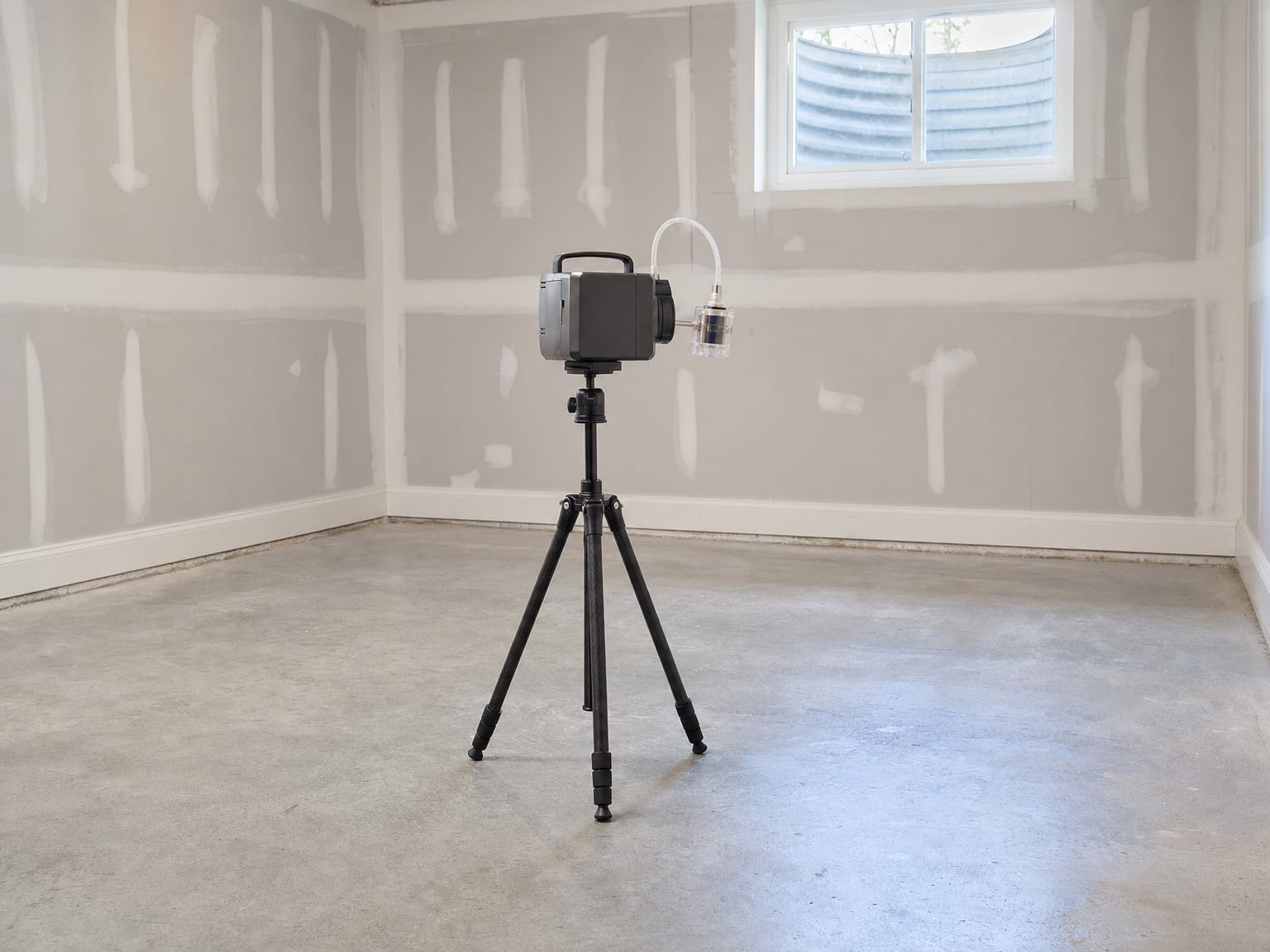 Moisture meter probe pressed against a remediated wood joist inside a clean dry crawl space