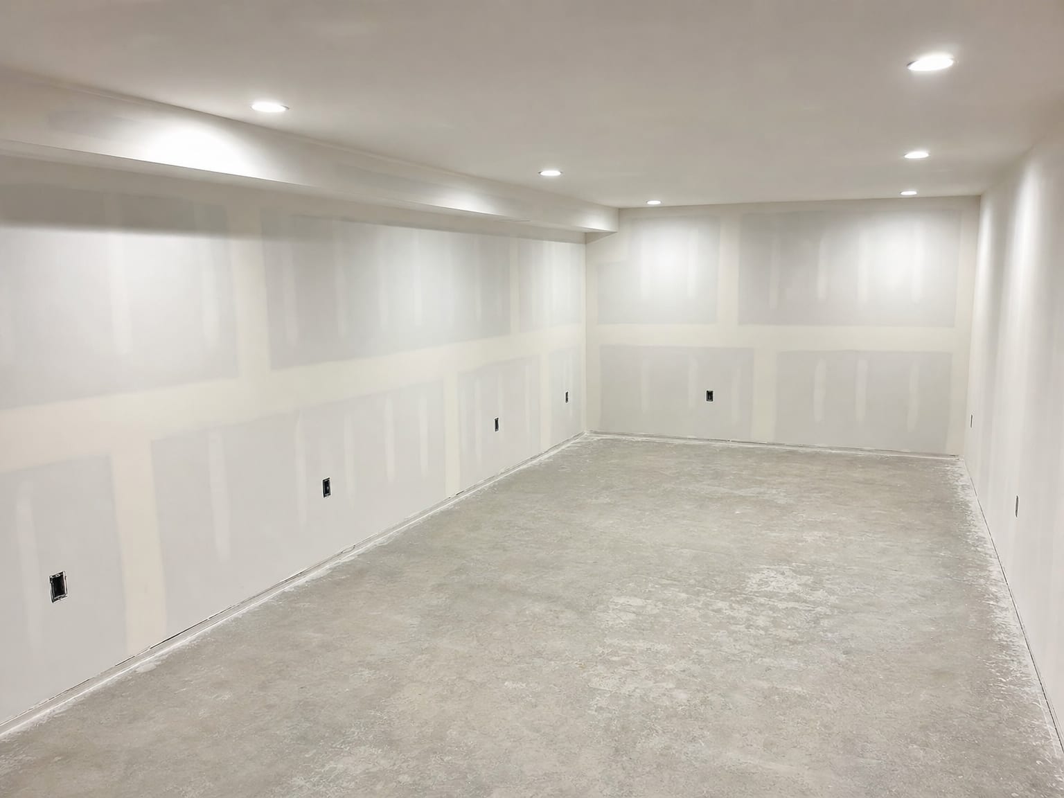 Wood framing studs and subfloor surface in a New Jersey basement treated with antimicrobial coating showing a uniformly dried white residue